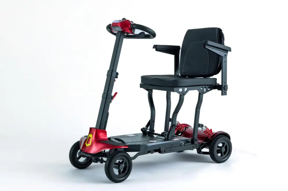 Red Genie folding mobility scooter with padded seat and adjustable armrests