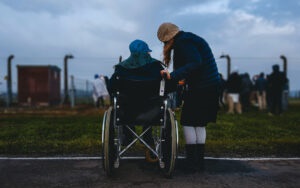 Person in a wheelchair and a friend standing next to them