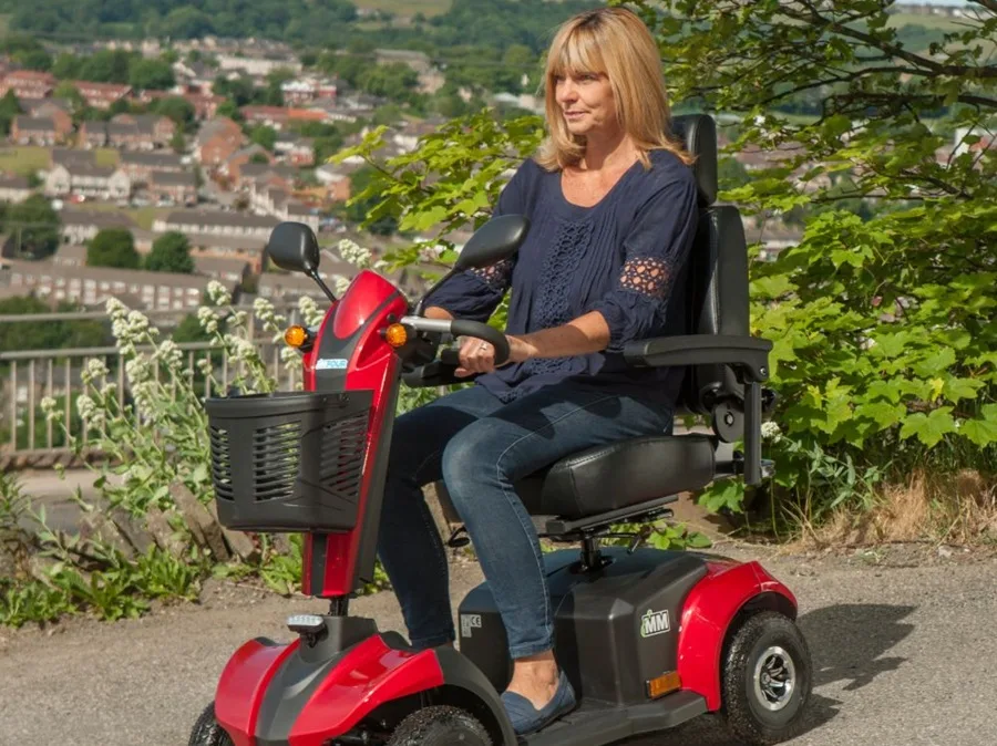 Middle aged lady on a red mobility scooter