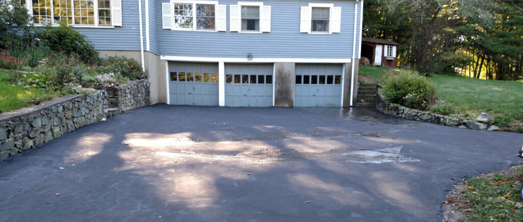 shot of a driveway with 3 garages in the background