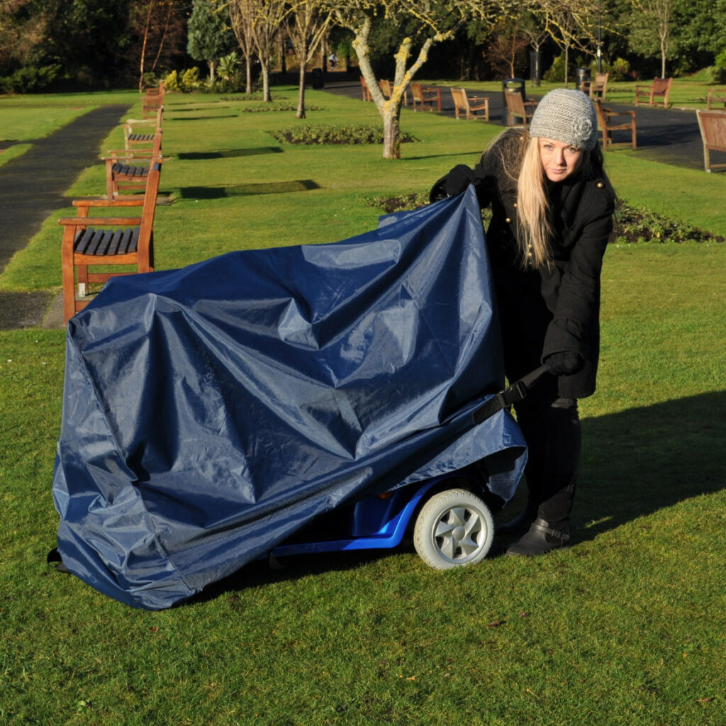 Woman putting a cover on a mobility scooter