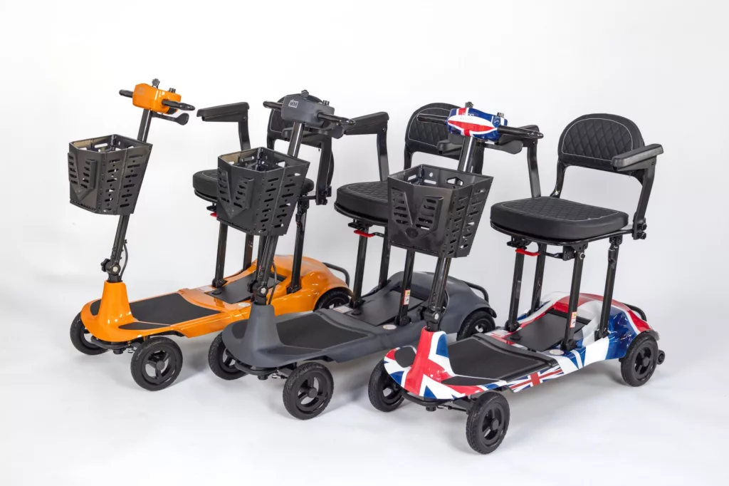 Side view of three Genie Ultralight mobility scooters: in orange, grey and union jack pattern