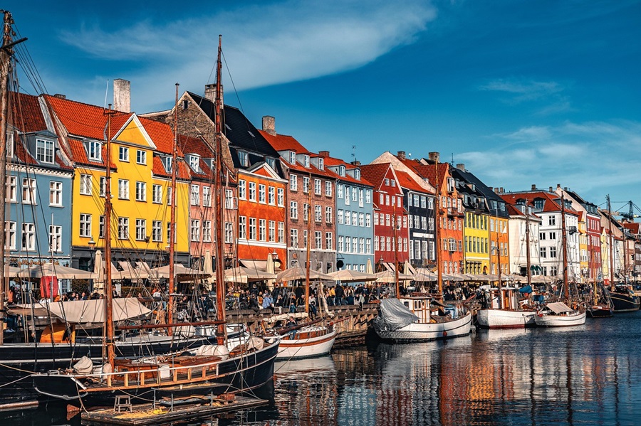 Colourful buildings and boats along the riverside in Copenhagen