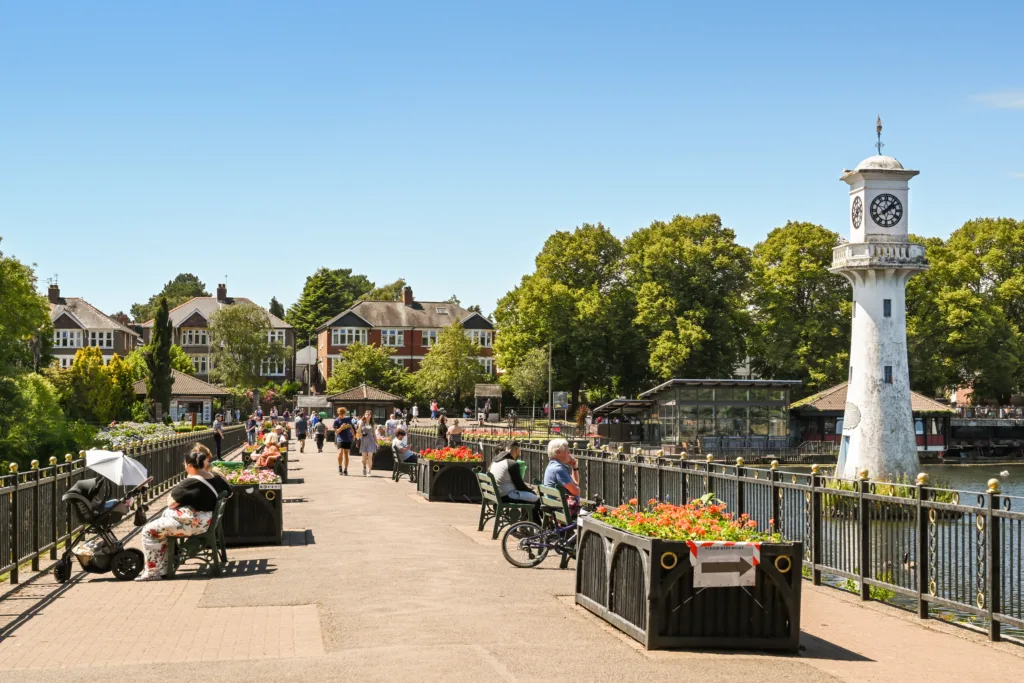 Clock tower and seating area on the promenade around Roath Lake in Cardiff