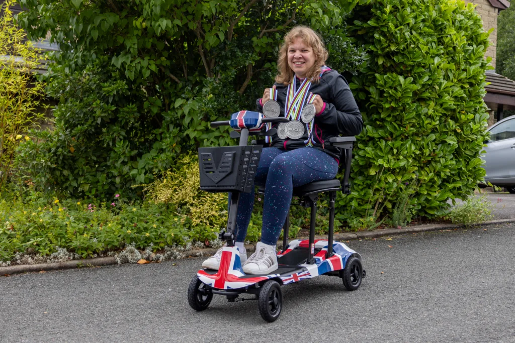 Katie Toft sitting on her Genie Ultralight mobility scooter