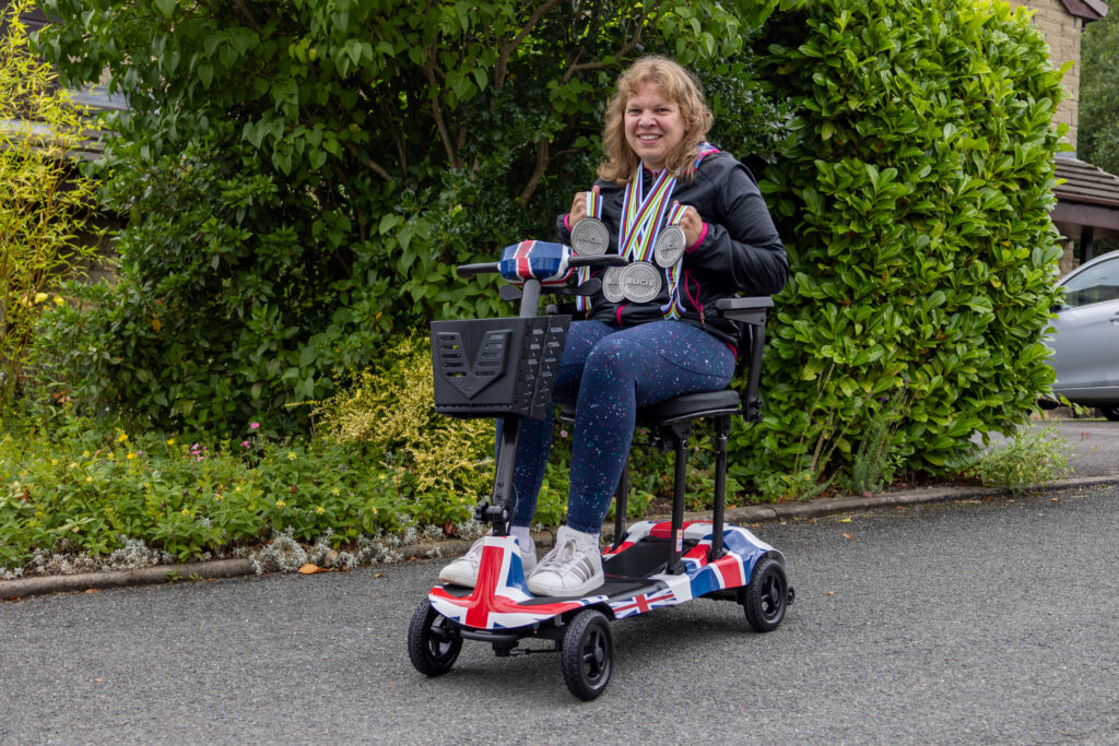 Katie Toft sitting on her Genie Ultralight mobility scooter